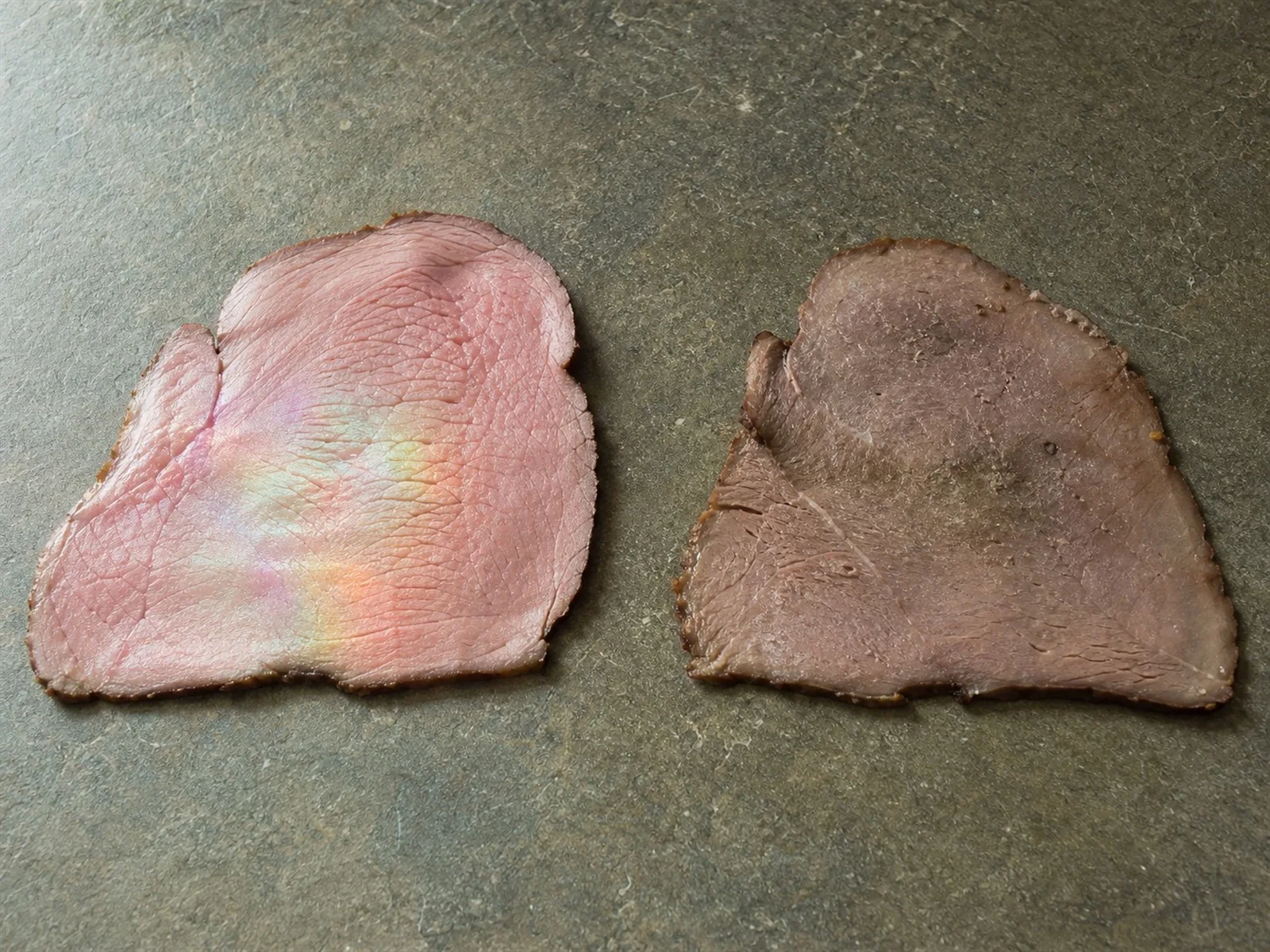 Slice of roast beef showing a natural rainbow iridescent sheen next to a visibly spoiled, slimy slice of deli meat